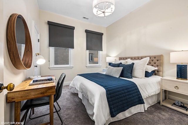 bedroom with carpet floors, visible vents, and a chandelier