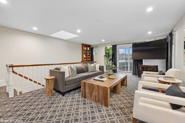 carpeted living area with a skylight and recessed lighting