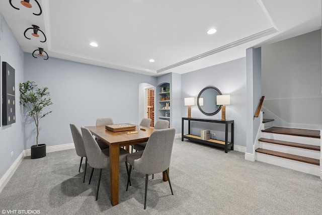 carpeted dining space with baseboards, stairway, and recessed lighting