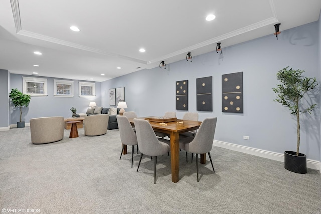 dining space with light carpet, baseboards, a tray ceiling, crown molding, and recessed lighting