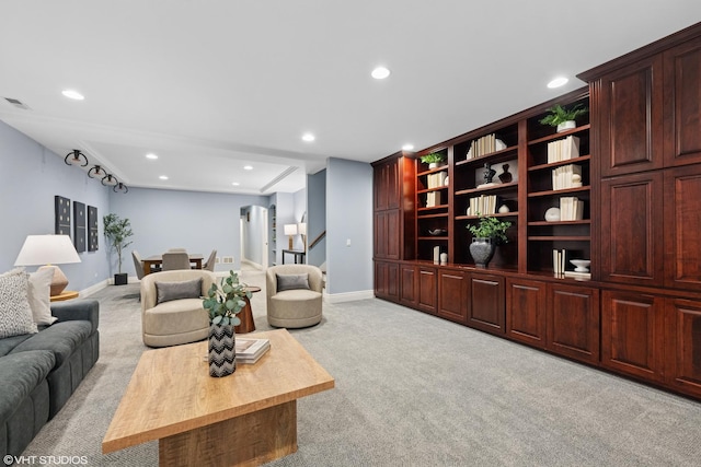 living room with recessed lighting, visible vents, baseboards, and light colored carpet