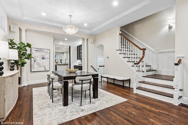 dining space with dark wood-style floors, ornamental molding, stairway, and ornate columns