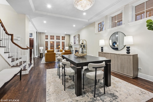 dining space with recessed lighting, stairway, an inviting chandelier, and wood finished floors