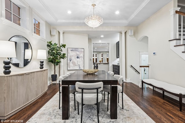 dining area with dark wood-style floors, a tray ceiling, crown molding, and ornate columns