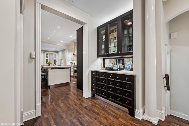 bar featuring recessed lighting, dark wood-style flooring, arched walkways, and baseboards