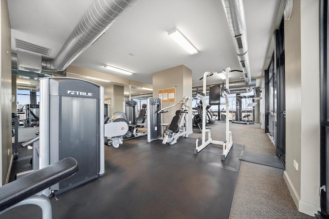 exercise room featuring visible vents and baseboards