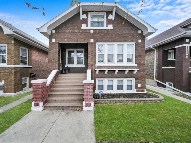 view of front of house with a front lawn and brick siding