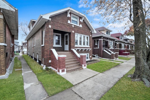 view of front of property with brick siding and a front lawn