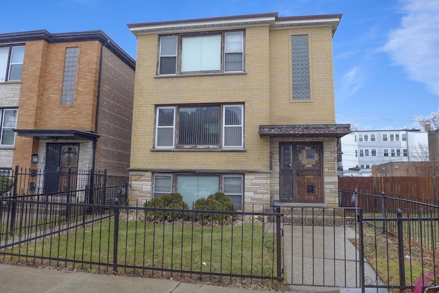 view of front of home featuring a fenced front yard, stone siding, and brick siding