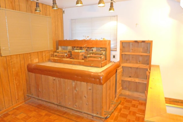 staircase featuring wooden walls