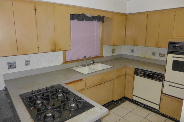 kitchen with white appliances, light tile patterned floors, light countertops, and a sink