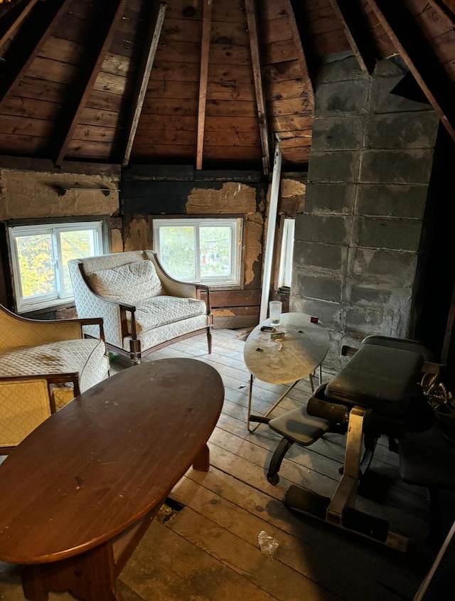 unfurnished room featuring vaulted ceiling with beams, wood-type flooring, and wooden ceiling