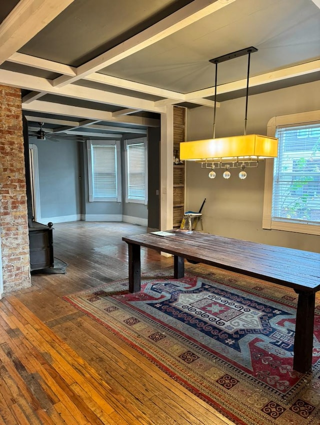 dining space with beam ceiling, baseboards, and hardwood / wood-style floors