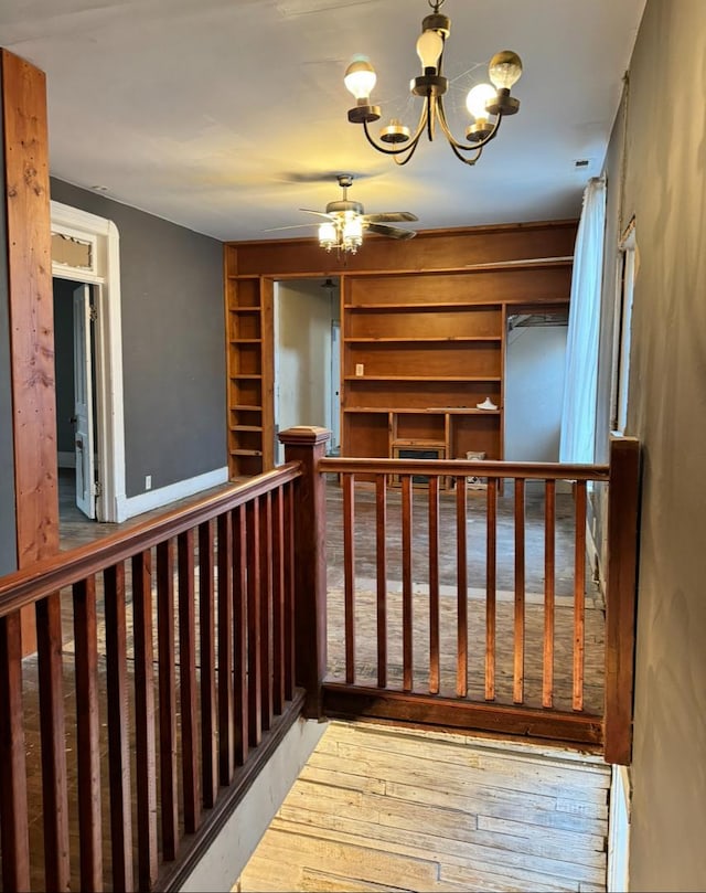 hallway featuring hardwood / wood-style floors and a notable chandelier