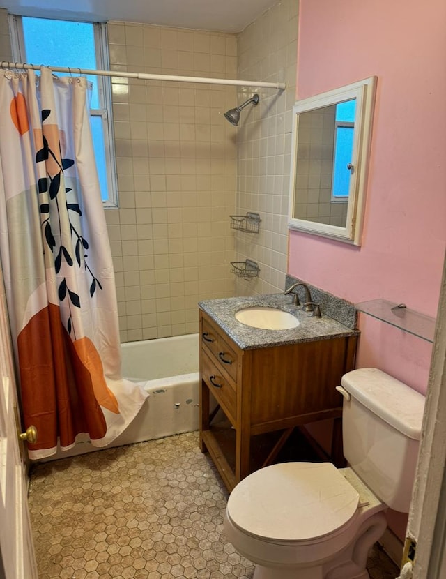 full bath featuring toilet, shower / tub combo with curtain, and vanity