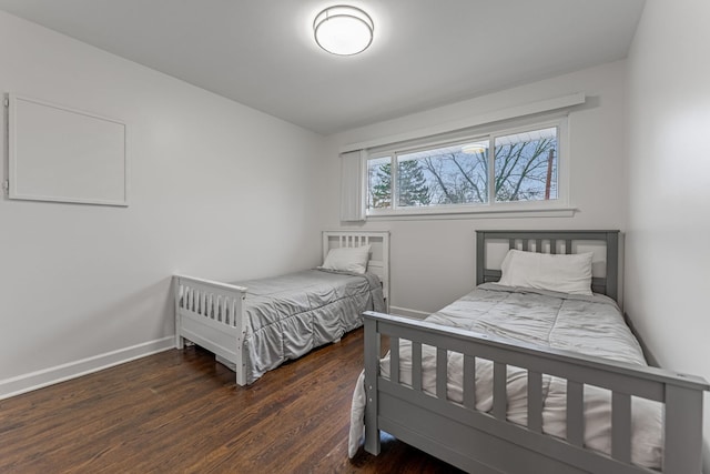 bedroom featuring baseboards and wood finished floors