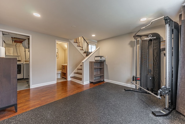 exercise room with washer and dryer, recessed lighting, baseboards, and wood finished floors