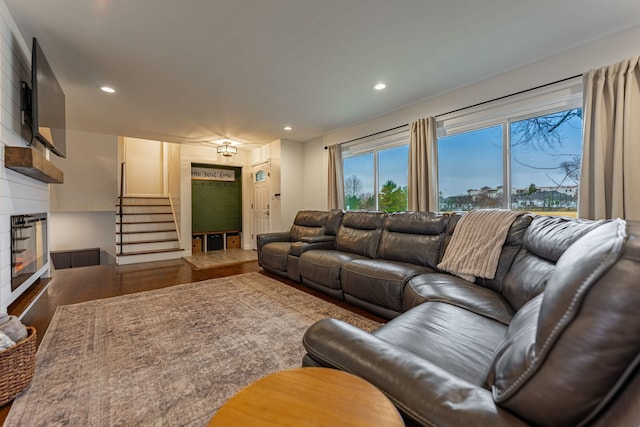 living area with recessed lighting, stairway, and wood finished floors