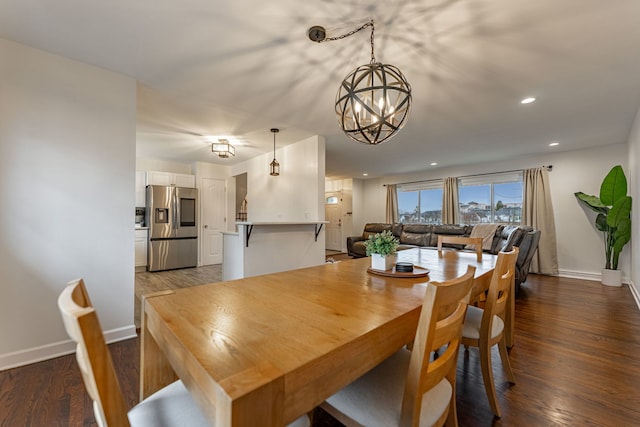 dining space with a notable chandelier, baseboards, wood finished floors, and recessed lighting