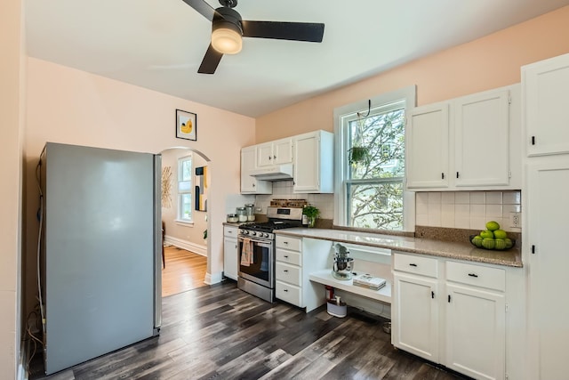 kitchen featuring appliances with stainless steel finishes, white cabinets, a ceiling fan, and under cabinet range hood