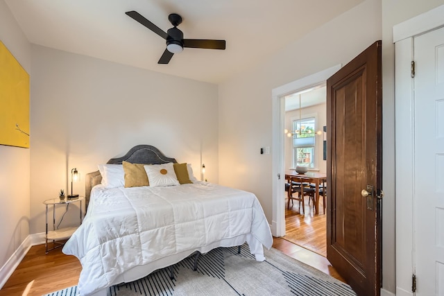 bedroom with baseboards, ceiling fan, and light wood finished floors