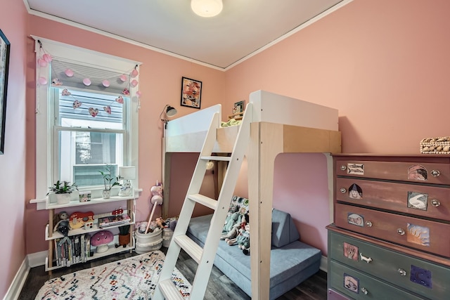 bedroom featuring baseboards, ornamental molding, and wood finished floors
