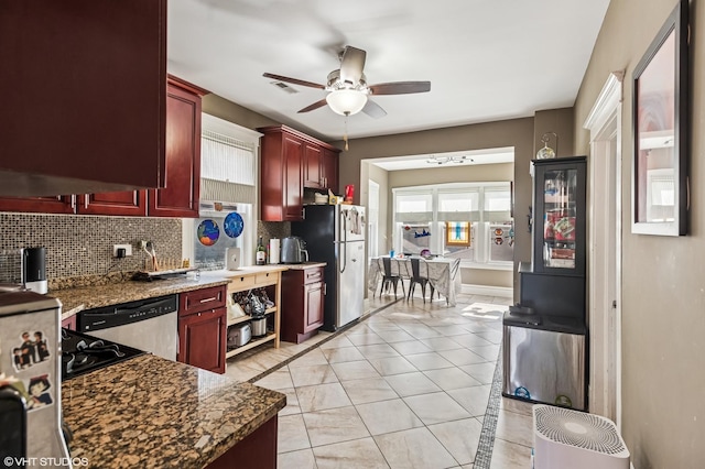 kitchen with light tile patterned flooring, freestanding refrigerator, reddish brown cabinets, tasteful backsplash, and dishwasher