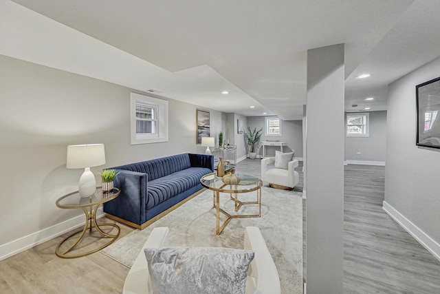 living area featuring recessed lighting, baseboards, and wood finished floors