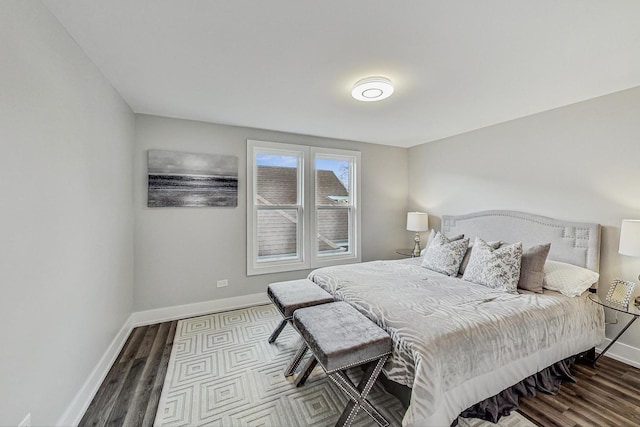 bedroom with dark wood-style floors and baseboards