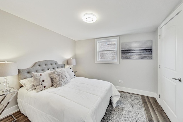 bedroom featuring wood finished floors and baseboards