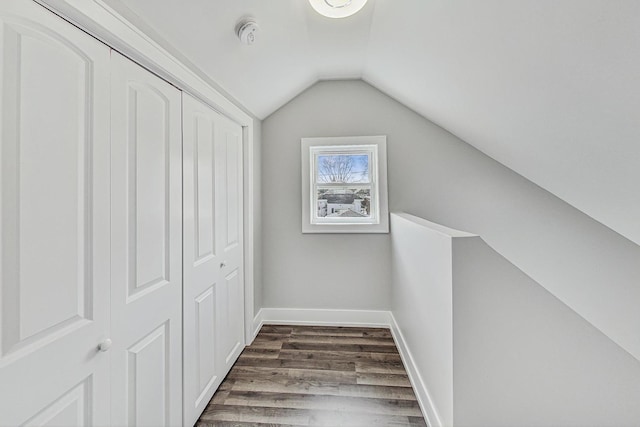 bonus room featuring lofted ceiling, baseboards, and wood finished floors