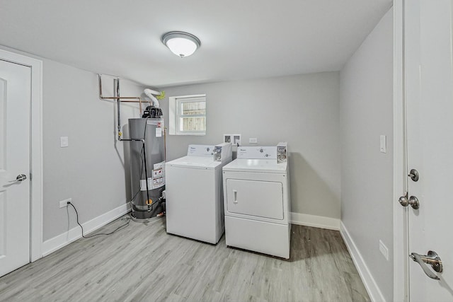 laundry area featuring gas water heater, light wood-style flooring, washer and dryer, laundry area, and baseboards