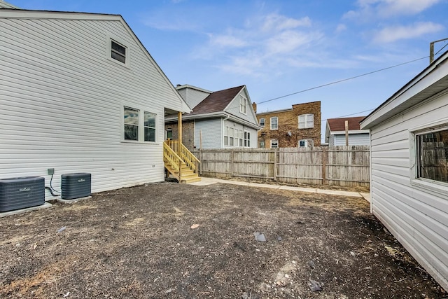 view of yard with fence and central air condition unit