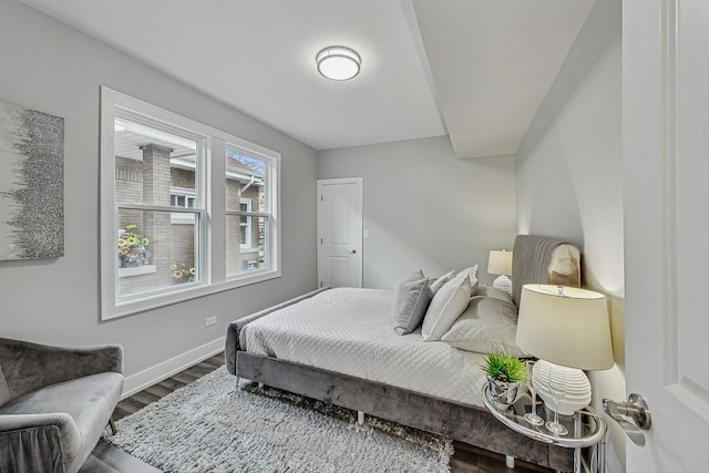 bedroom with wood finished floors and baseboards