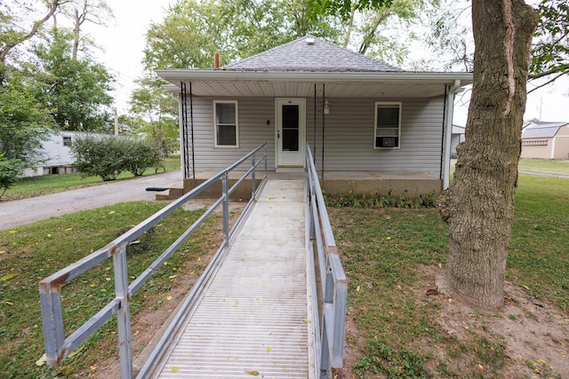 bungalow with a shingled roof and driveway