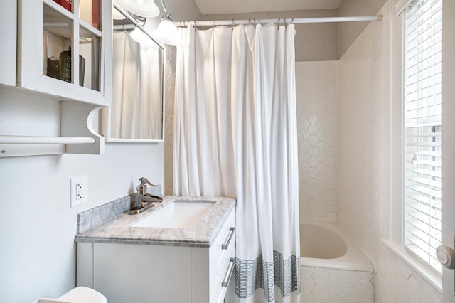 bathroom with shower / tub combo and vanity