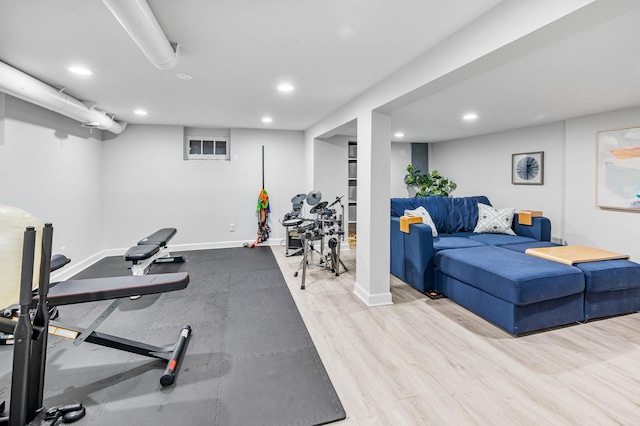 exercise area with baseboards, wood finished floors, and recessed lighting