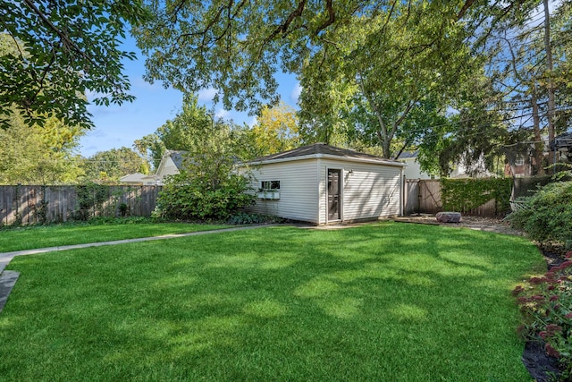 view of yard featuring a fenced backyard and an outbuilding