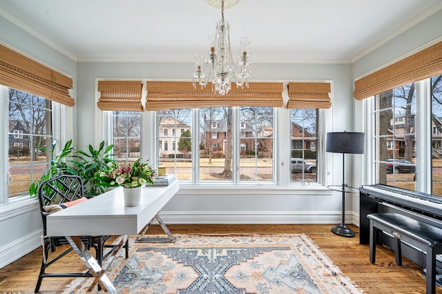 sunroom / solarium with a wealth of natural light and a notable chandelier