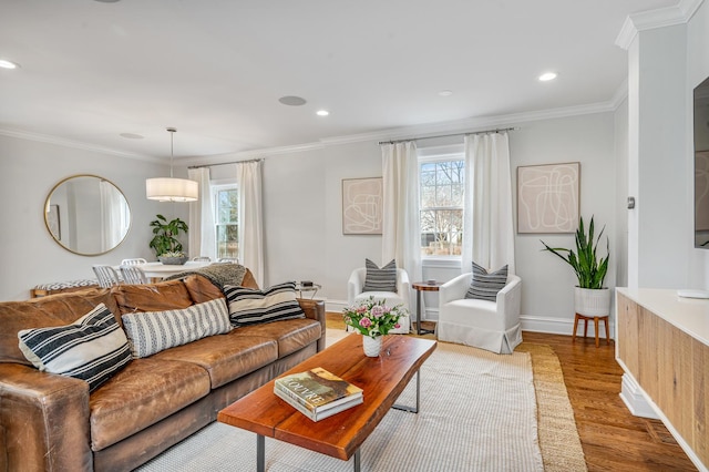 living room with ornamental molding, recessed lighting, wood finished floors, and baseboards