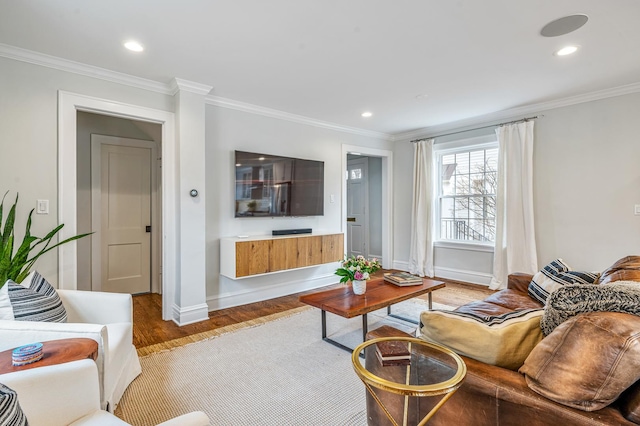 living room with ornamental molding, light wood-type flooring, and recessed lighting