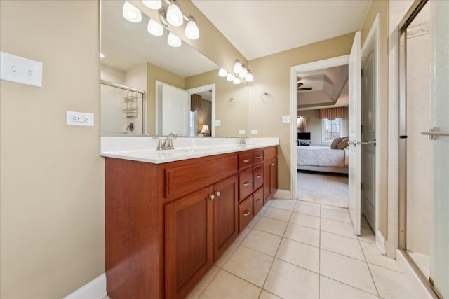 bathroom with double vanity, ensuite bathroom, a stall shower, a sink, and tile patterned floors