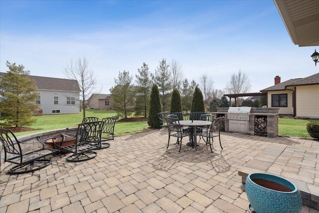 view of patio / terrace with outdoor dining area, area for grilling, and a grill