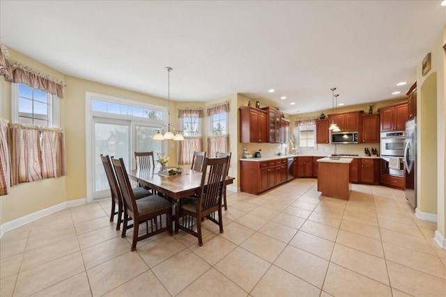 dining space featuring baseboards, light tile patterned floors, a notable chandelier, and recessed lighting