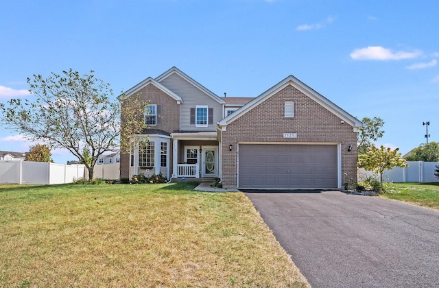 traditional-style home featuring an attached garage, brick siding, fence, driveway, and a front lawn