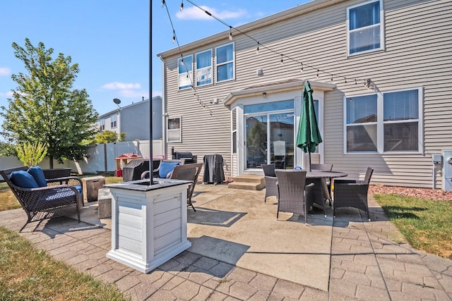 view of patio / terrace featuring entry steps, an outdoor living space with a fire pit, and fence