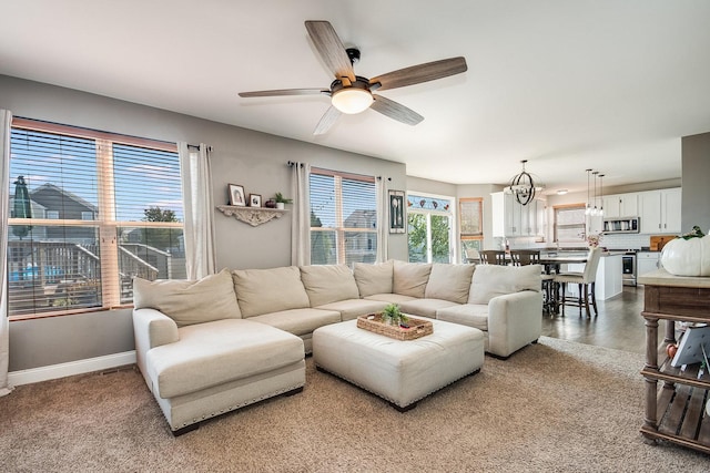 living room featuring ceiling fan and baseboards