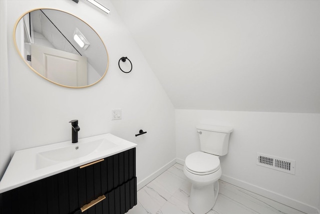 bathroom featuring baseboards, visible vents, toilet, lofted ceiling, and marble finish floor