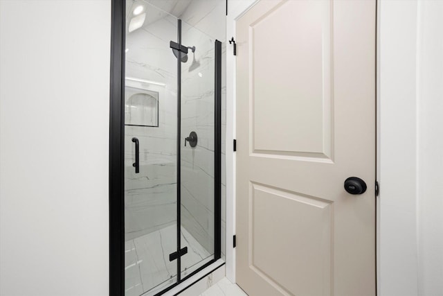 bathroom with a marble finish shower