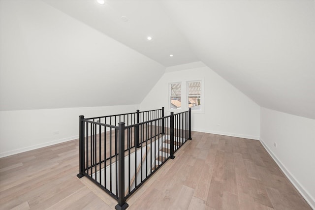 bonus room featuring light wood-type flooring, lofted ceiling, baseboards, and recessed lighting